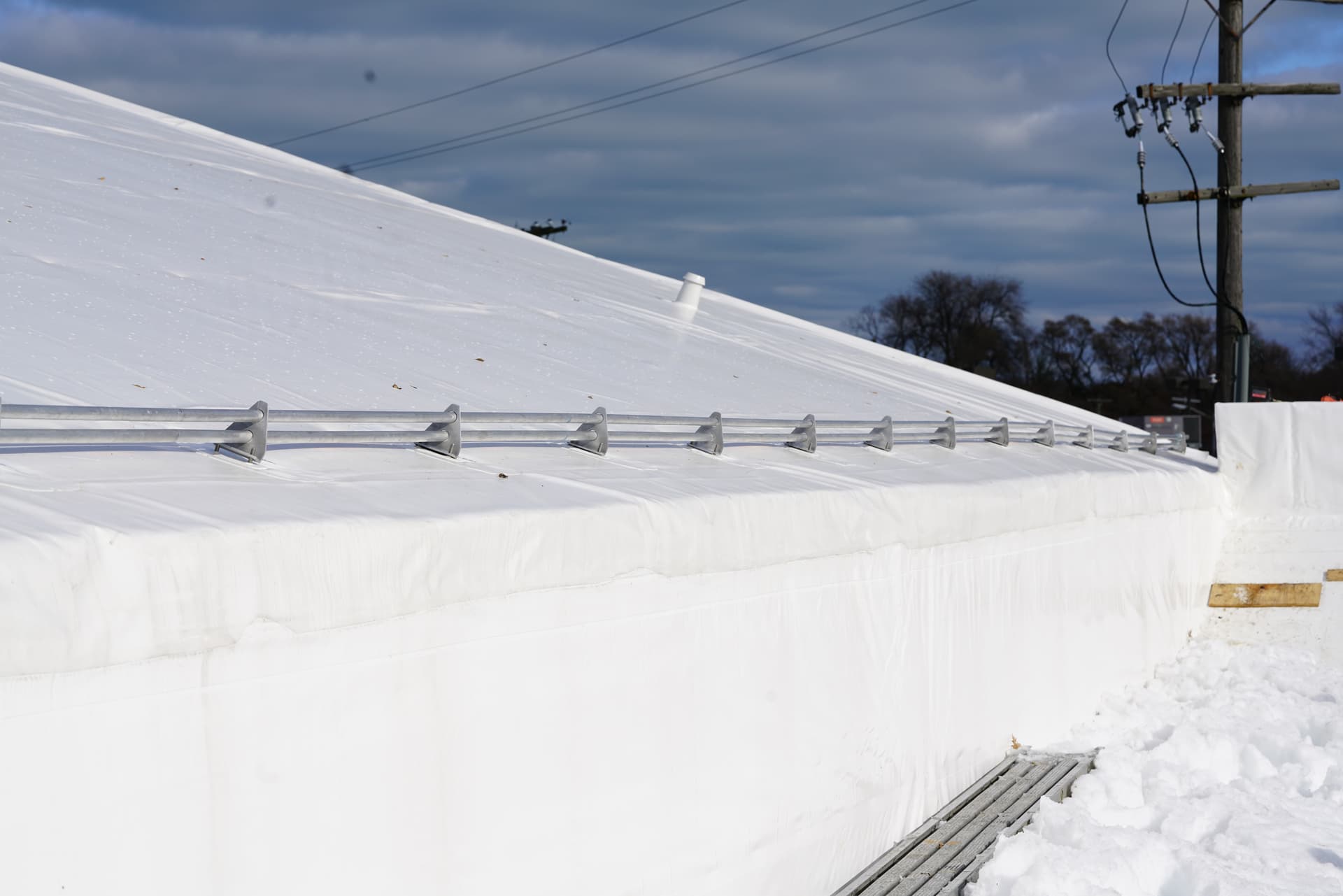 Snow rail along the eave of a snow-covered roof
