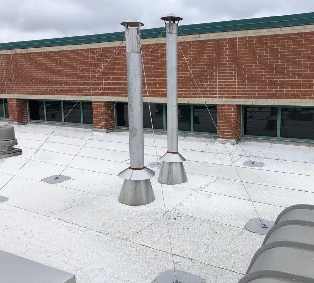 Anchor bases set across a finished membrane roof